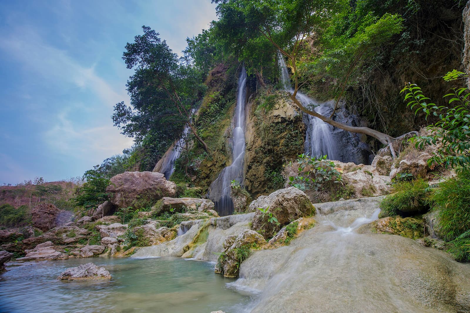 Sri Gethuk waterfall cascading over limestone ledges into the river