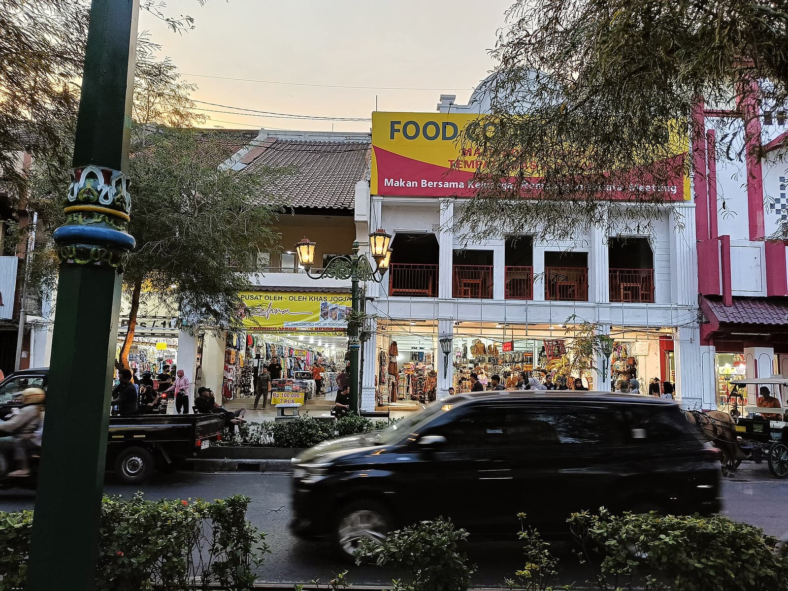 Shopfronts and evening traffic on Malioboro street in Yogyakarta